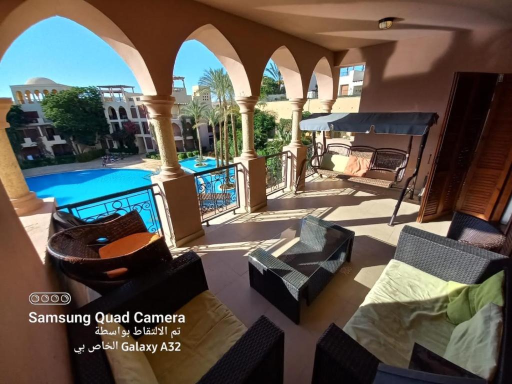 a view of a patio with chairs and a swimming pool at Talabay AQABA in Aqaba