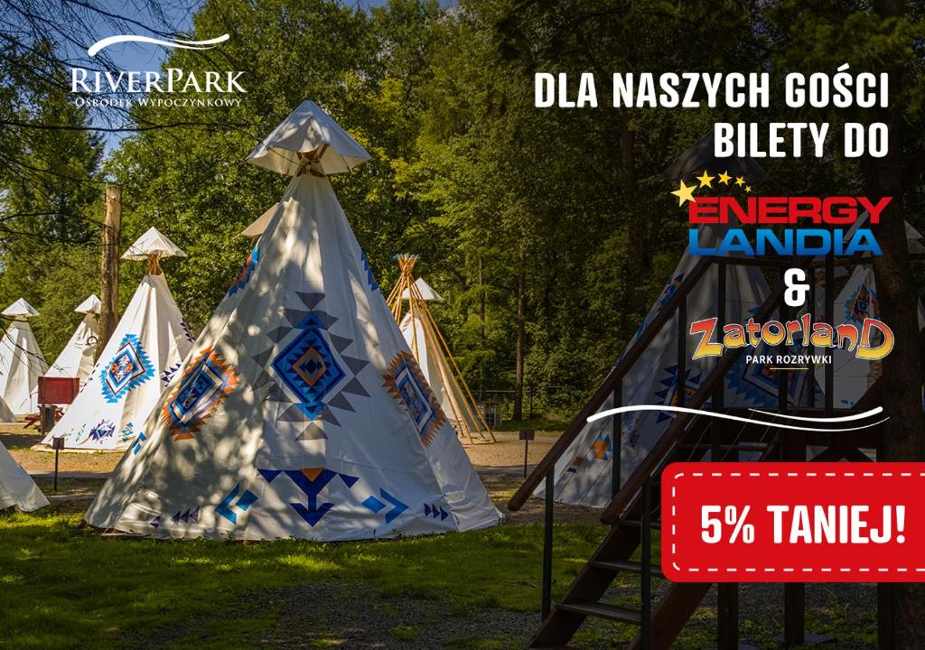 a teepee tent with a sign in a park at Wioska Indiańska River Park in Zator