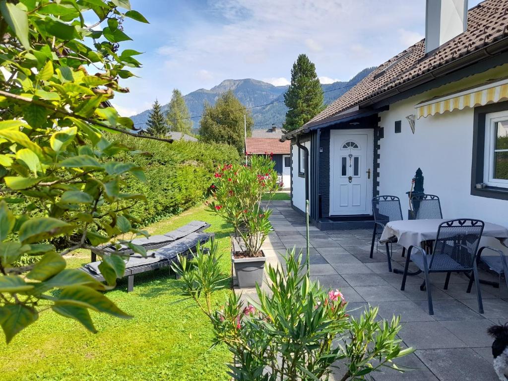 a patio with a table and chairs in a yard at Mira in Bad Mitterndorf