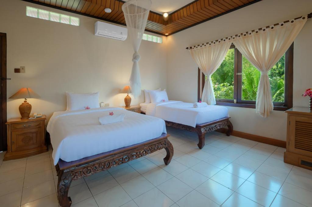 Postel nebo postele na pokoji v ubytování Banyualit Spa 'n Resort Lovina