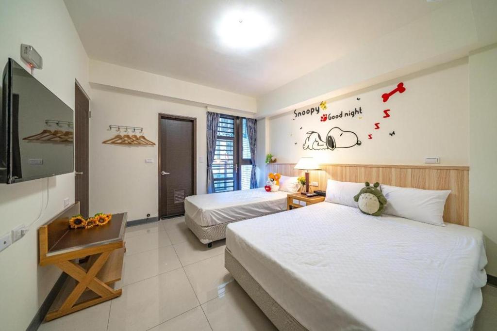 Postel nebo postele na pokoji v ubytování 礁溪幸福民宿Jiaoxi Happy Homestay