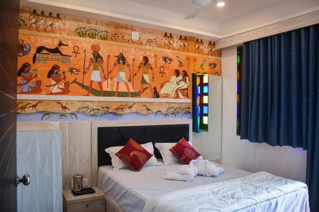 a bedroom with a bed with a painting on the wall at Hotel Lake Bridge in Udaipur