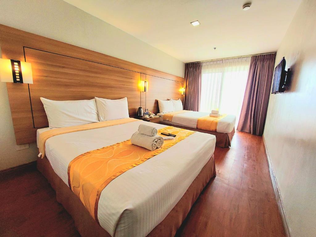Postel nebo postele na pokoji v ubytování Tagaytay Hotel SixB