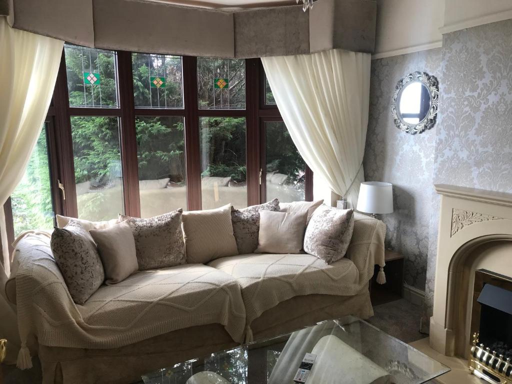 a living room with a couch in front of a window at 3 bedroom home with stunning views and hot tub in Birmingham