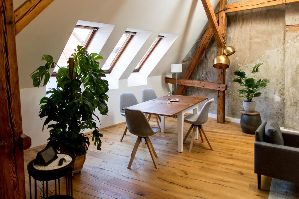 a dining room with a table and chairs and skylights at Studio Loft Murau - im Herzen der Altstadt in Murau