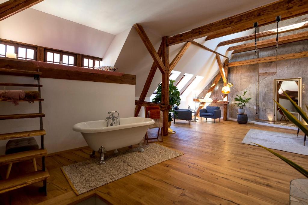 a bathroom with a bath tub in the middle of a room at Studio Loft Murau - im Herzen der Altstadt in Murau
