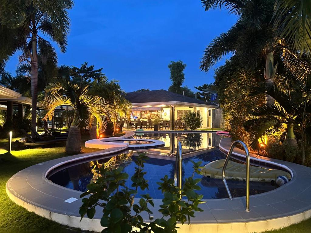 a house with a swimming pool at night at Alona Royal Palm Resort in Panglao