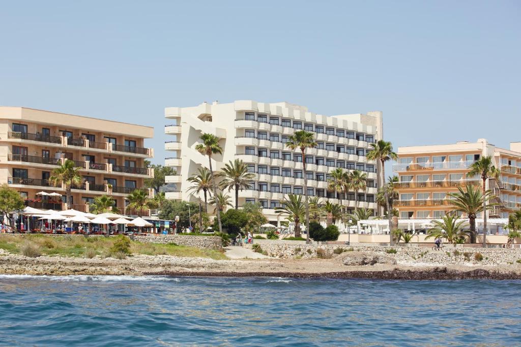 a view of a resort from the water at Hotel Sabina Playa in Cala Millor
