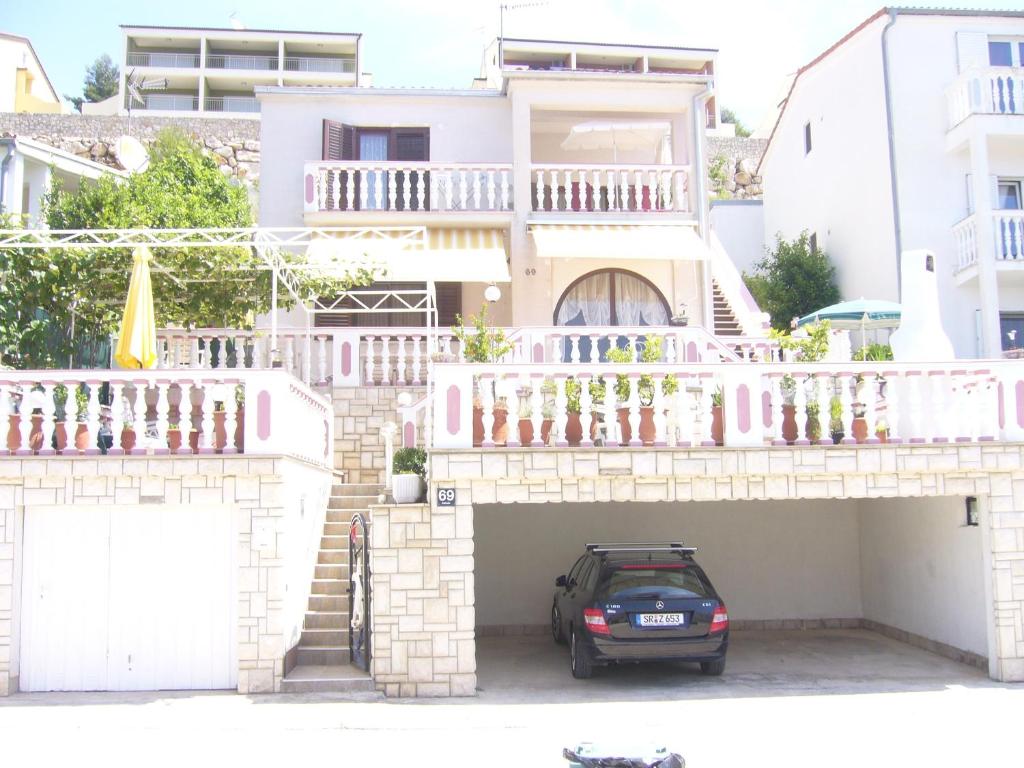 a car parked in a parking lot in front of a house at Apartment Branko in Drage