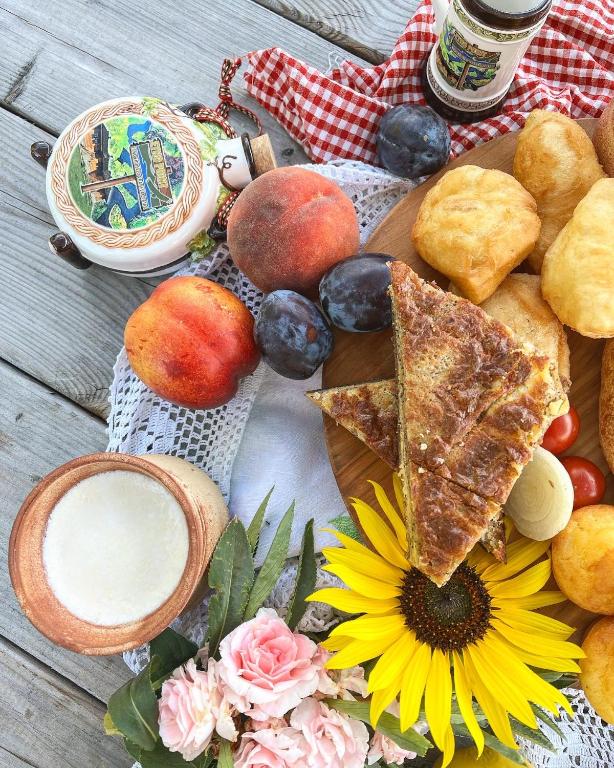 a plate of food with bread and fruit and a drink at ETNO SELO VRANEŠA Zlatar in Nova Varoš