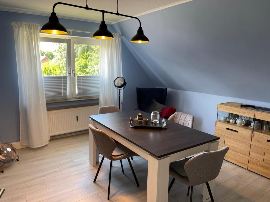 - une salle à manger avec une table et des chaises dans l'établissement Ferienwohnung Ankerplatz, à Emden