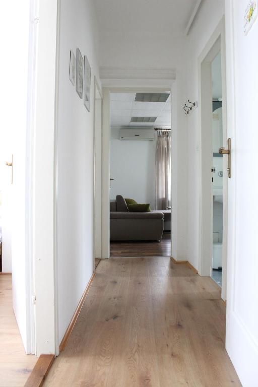 a hallway with a living room with a couch at West Capital in Zagreb