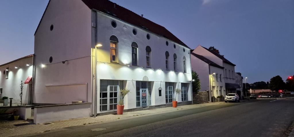 a white building on the side of a street at Le 1815 in Waterloo