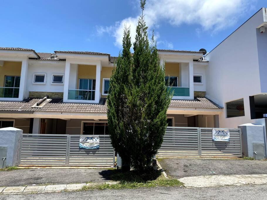 a small tree in front of a building at Azzalea Homes 1 @ Taman Golden Hills Cameron Highlands in Brinchang