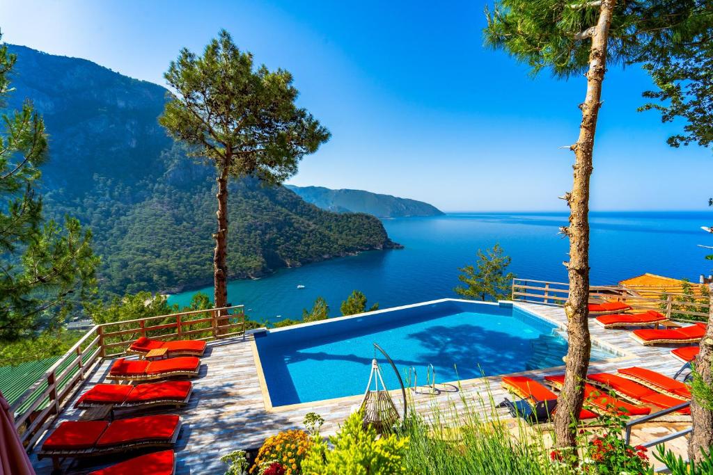 a swimming pool with a view of a lake at MANZARA BUNGALOW in Fethiye