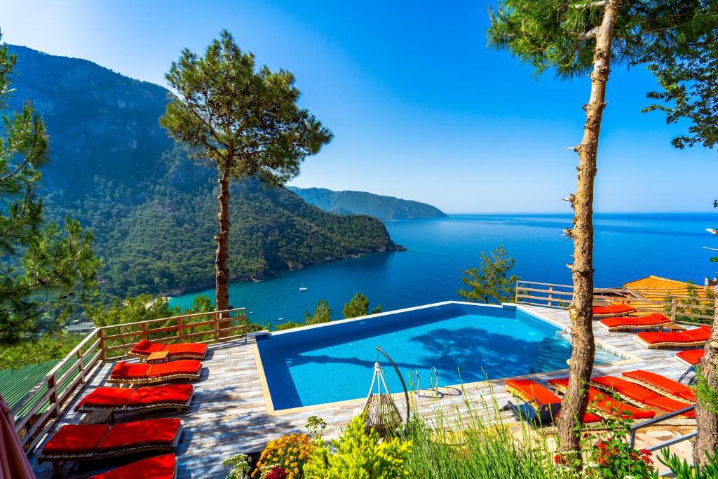 a swimming pool with a view of a lake at MANZARA BUNGALOW in Fethiye