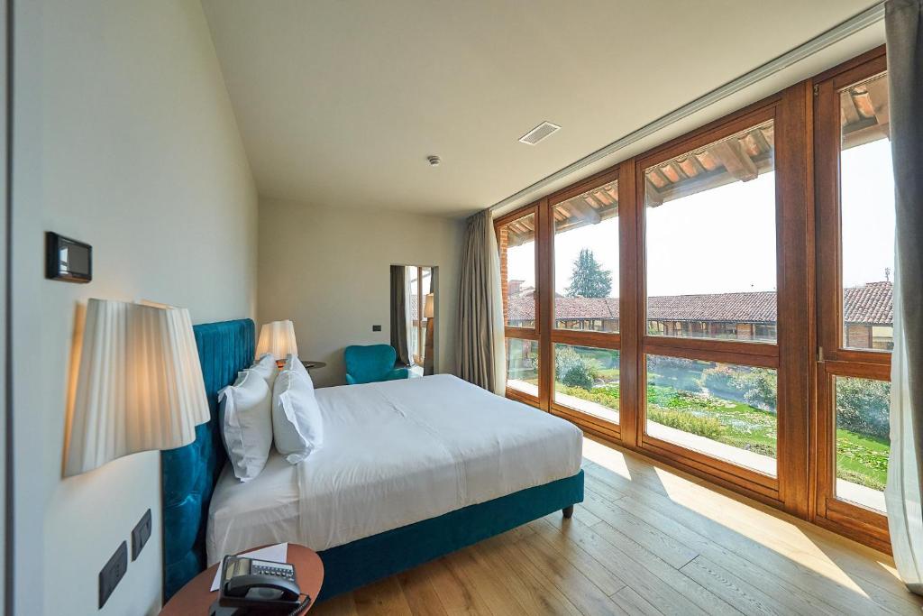 Postel nebo postele na pokoji v ubytování RELAIS CASCINA ERA