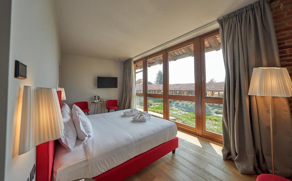 Postel nebo postele na pokoji v ubytování RELAIS CASCINA ERA