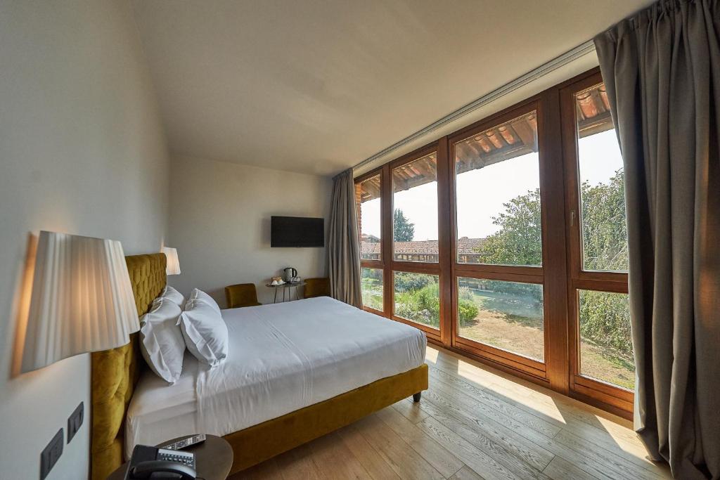 Postel nebo postele na pokoji v ubytování RELAIS CASCINA ERA