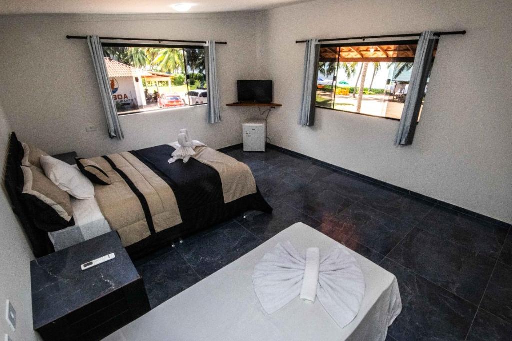 Ένα ή περισσότερα κρεβάτια σε δωμάτιο στο Camboa Suítes