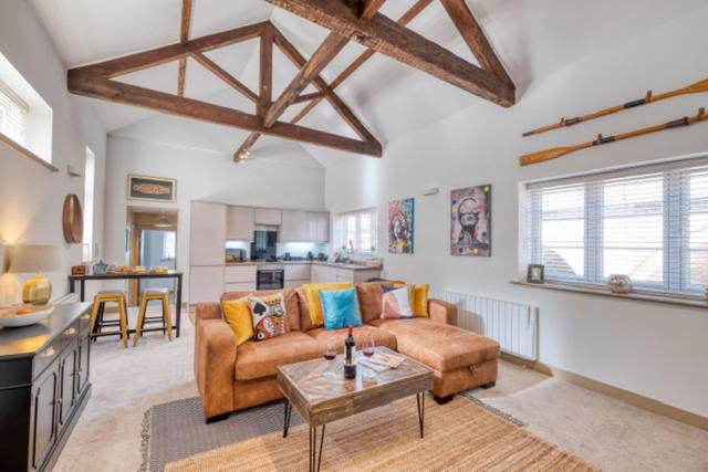 een woonkamer met een bank en een tafel bij Gorgeous 1-bed city apartment, sleeps 4 in Worcester