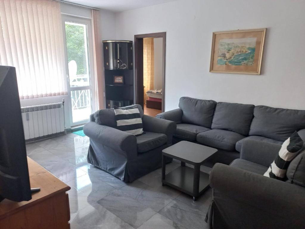 a living room with a couch and a table at Beautiful location apartment in Sofia