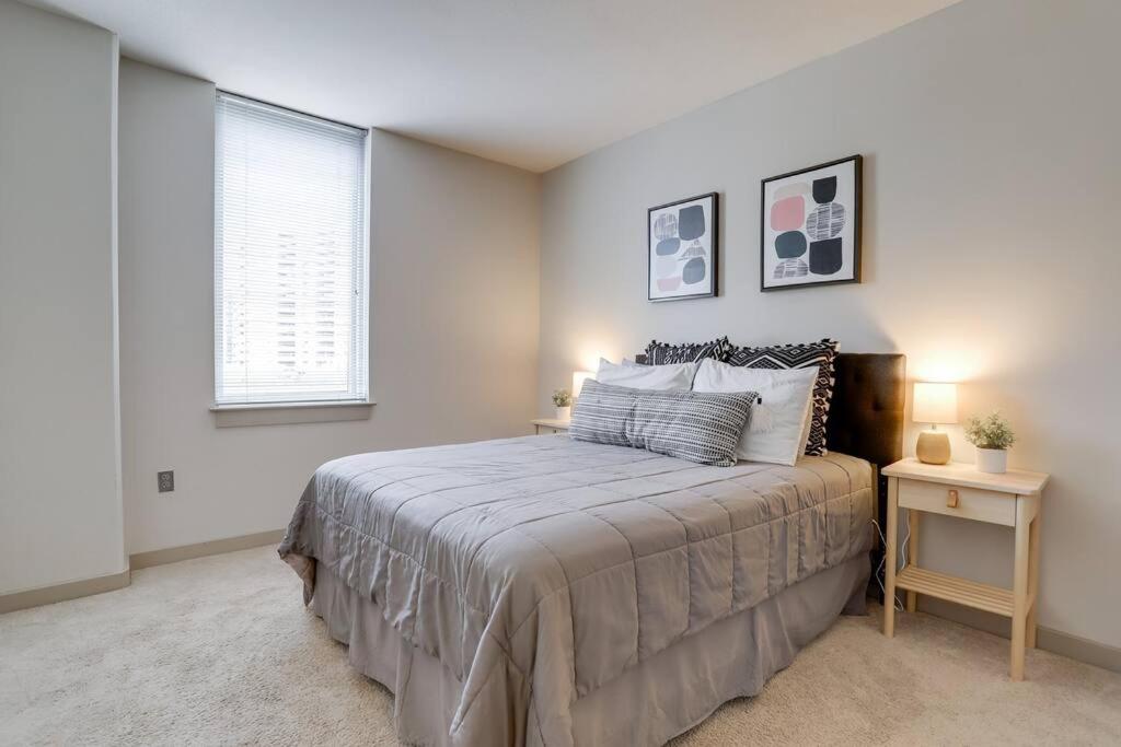 a bedroom with a large bed and a window at Stylish Condo at Crystal City With Rooftop in Arlington