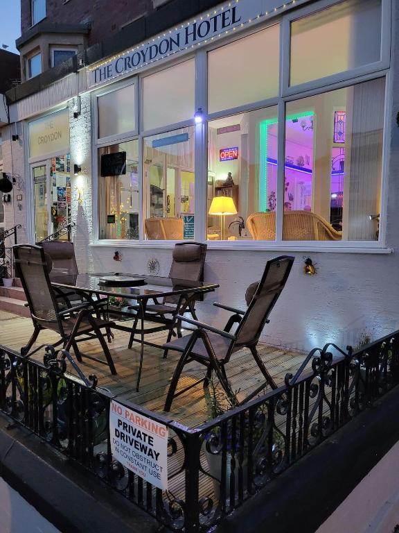 a restaurant with a table and chairs on a balcony at The Croydon in Blackpool
