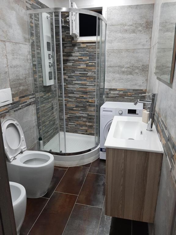 a bathroom with a shower and a toilet and a sink at Casa Elena in San Felice Circeo