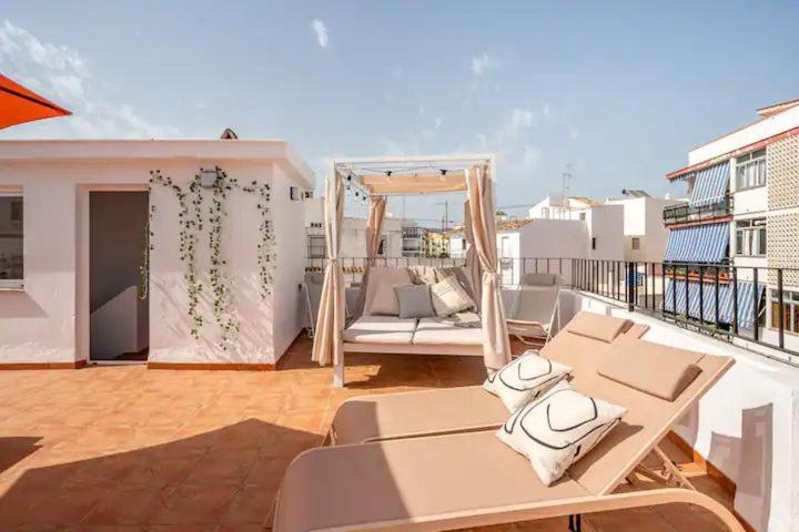 a balcony with a couch and a gazebo at ASTOR CENTRO. 360 roof terrace. Epicentre old town in Estepona