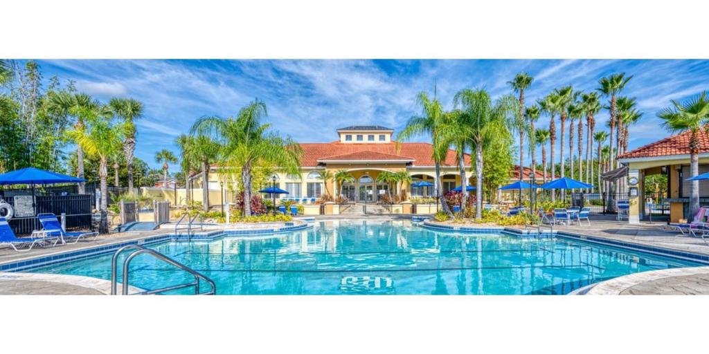 a swimming pool at a resort with palm trees at Terra Verde Vacation Rentals in Kissimmee