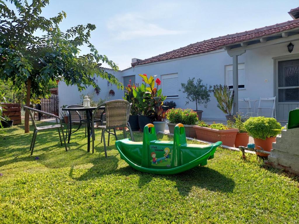 a green toy boat in the yard of a house at Agrikia tis Vasilikis in Ormília