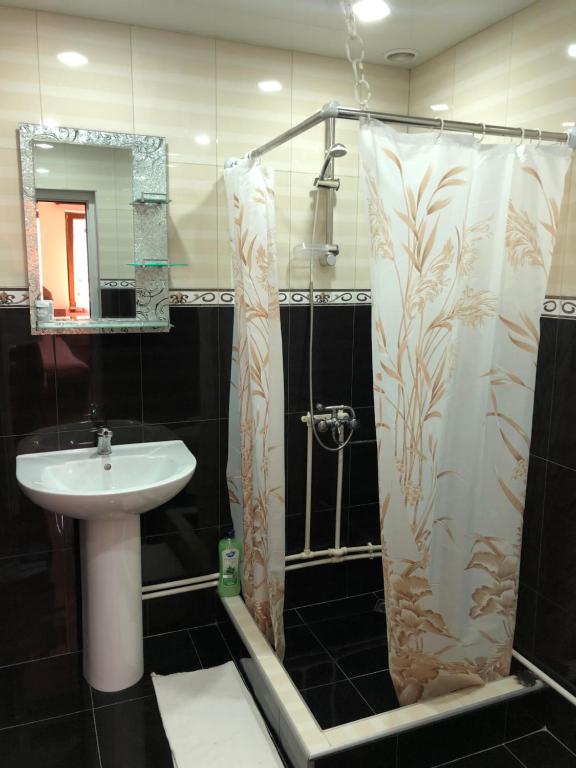 a bathroom with a sink and a shower curtain at Haer B&B in Meghri