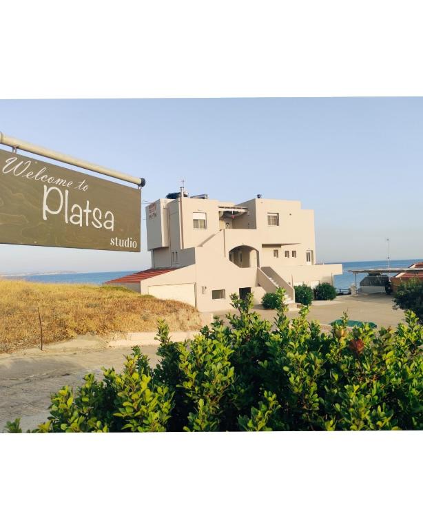 a building with a sign in front of it at Platsa Studios in Megás Limniónas