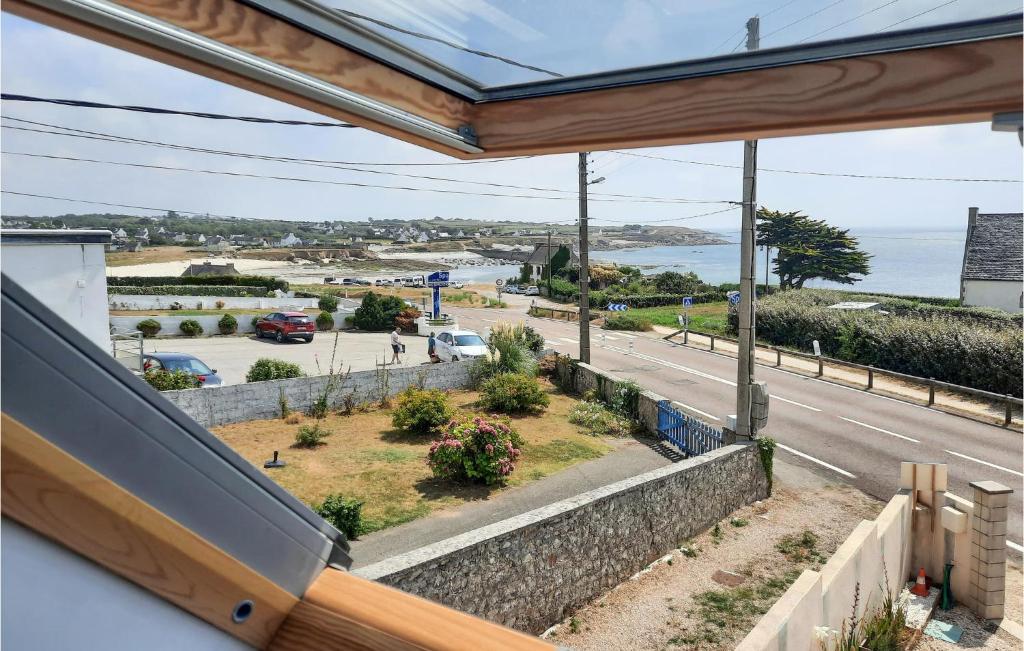 a balcony with a view of a road and the ocean at 2 Bedroom Lovely Home In Plogoff in Plogoff