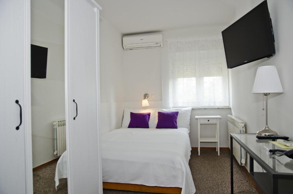 Postel nebo postele na pokoji v ubytování Hotel Fala Zagreb