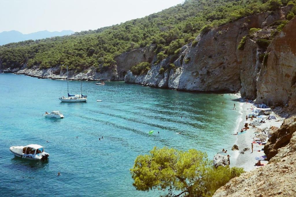 a group of people on a beach in a body of water at Victory's house, 3min walk to Skala's sandy beach in Skala