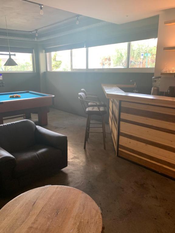 a living room with a pool table and a bar at Unique space in Gerakas - Cave in Athens