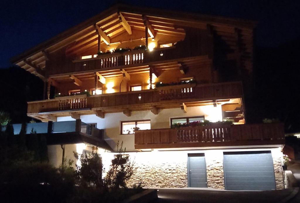 ein großes Gebäude mit Balkon in der Nacht in der Unterkunft Haus Raimund " KLEIN aber FEIN " in Alpbach
