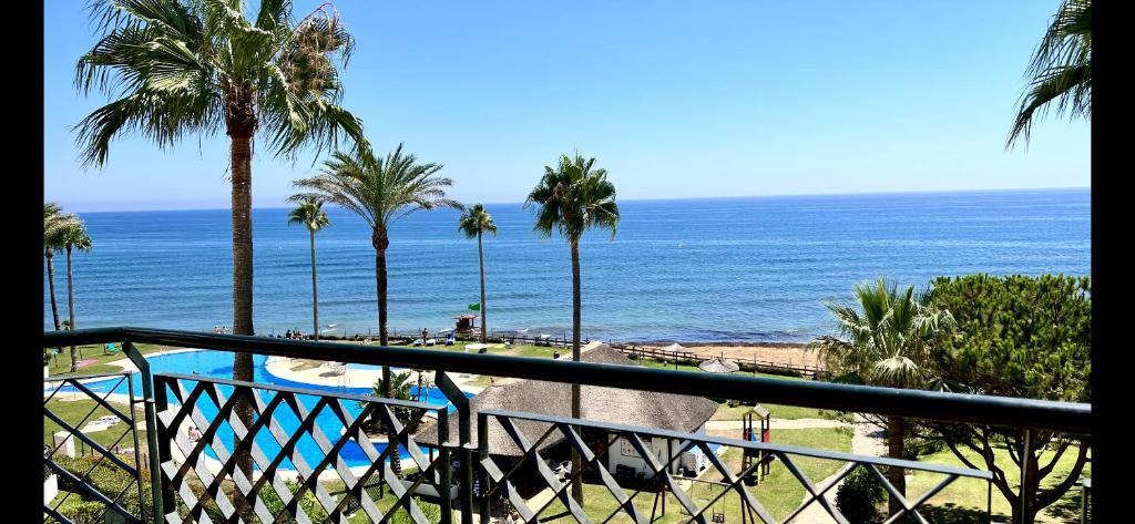 a view of the ocean from the balcony of a resort at MI CAPRICHO, Beach Front Apartment P14 3ºB in Mijas Costa