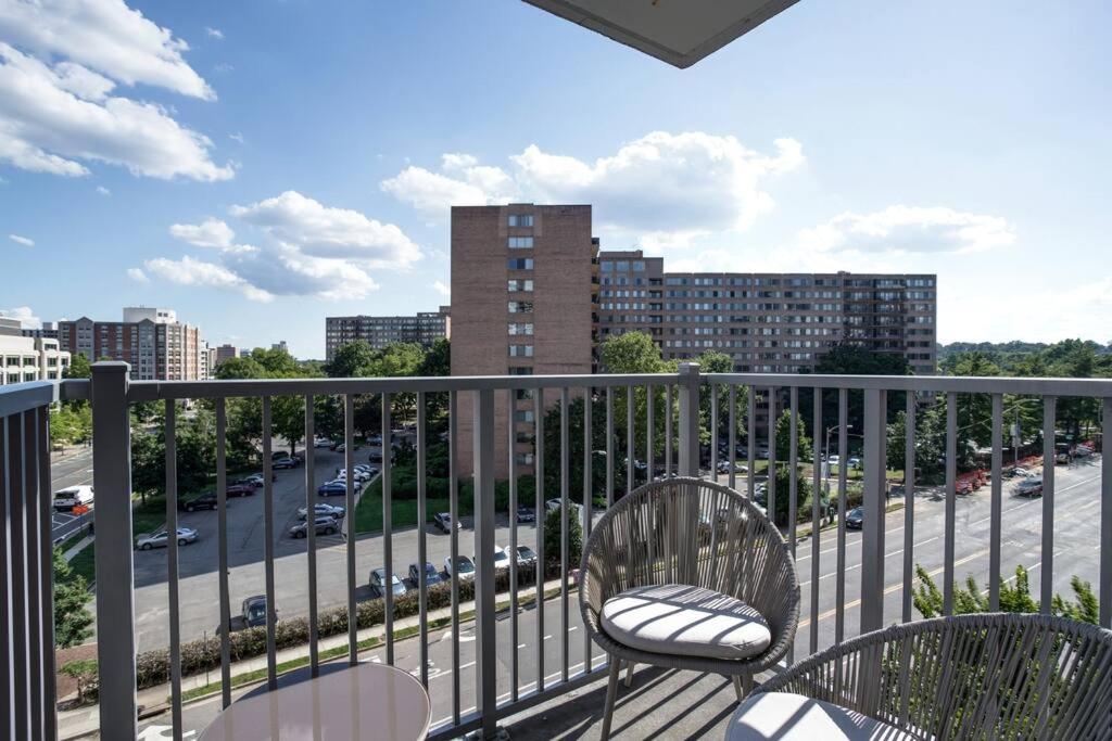 a balcony with two chairs and a city street at Exclusive Condo With Stunning Views at Crystal City in Arlington