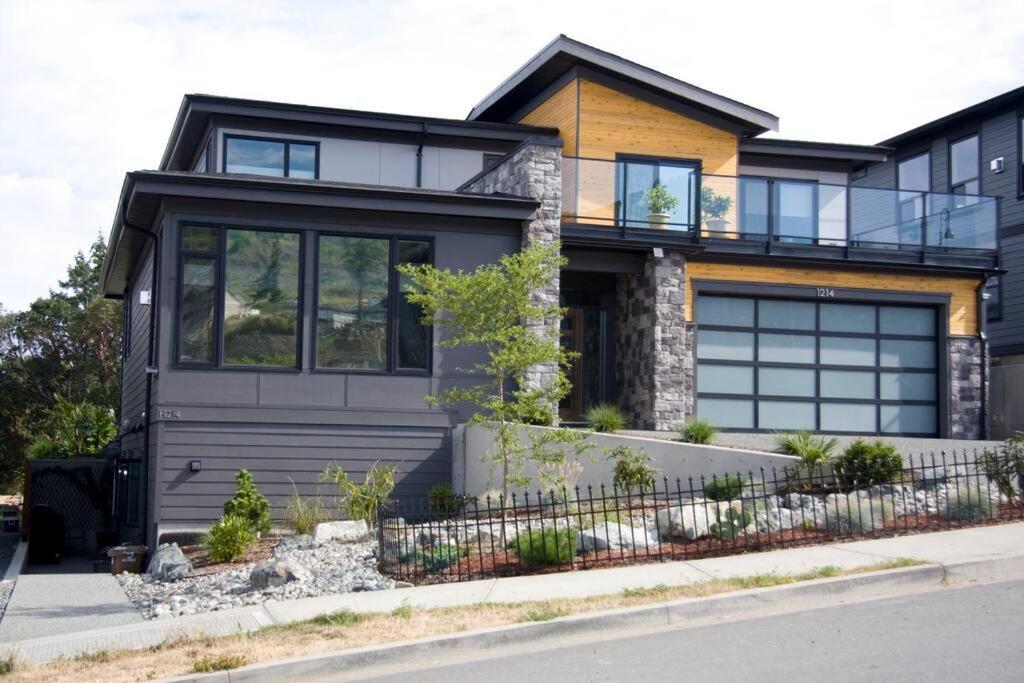 a house with a gray garage at Modern Mt Tzouhalem Suite with Panoramic Views in Duncan