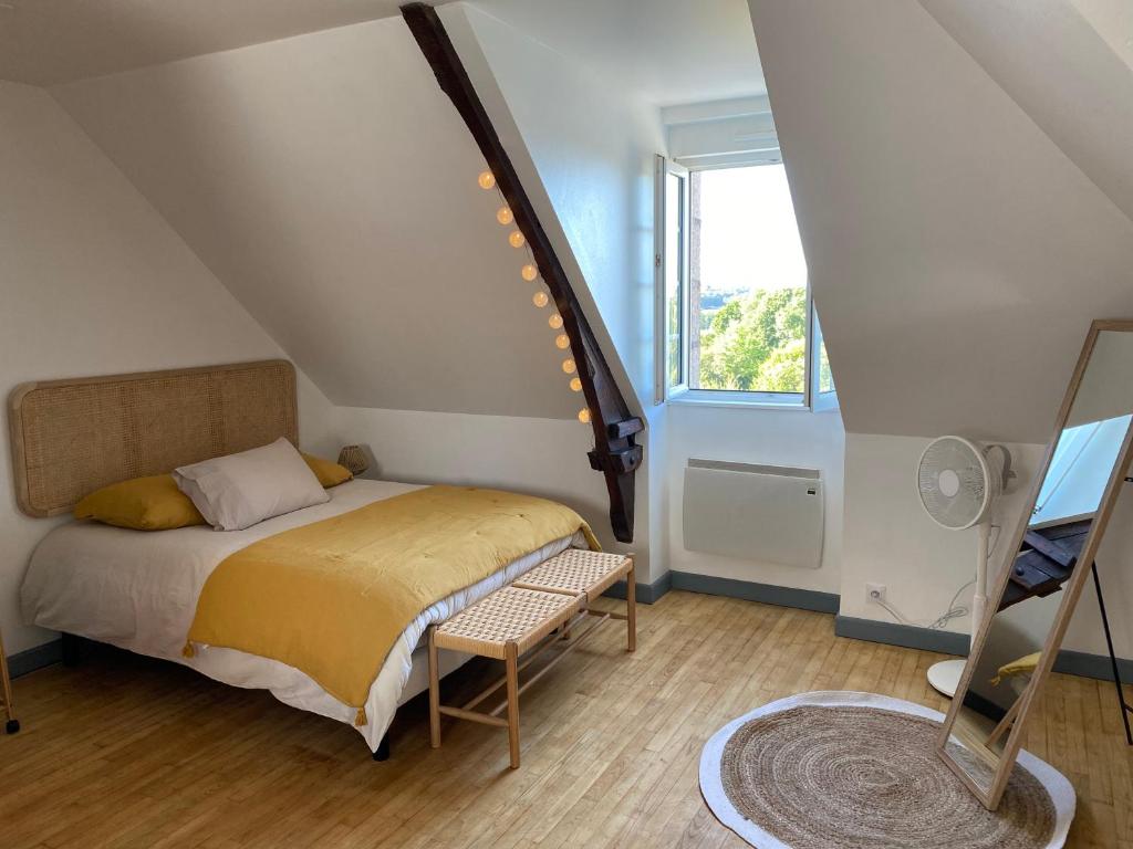 a small bedroom with a bed and a window at Studio Cocooning in Saint-Samson-sur-Rance