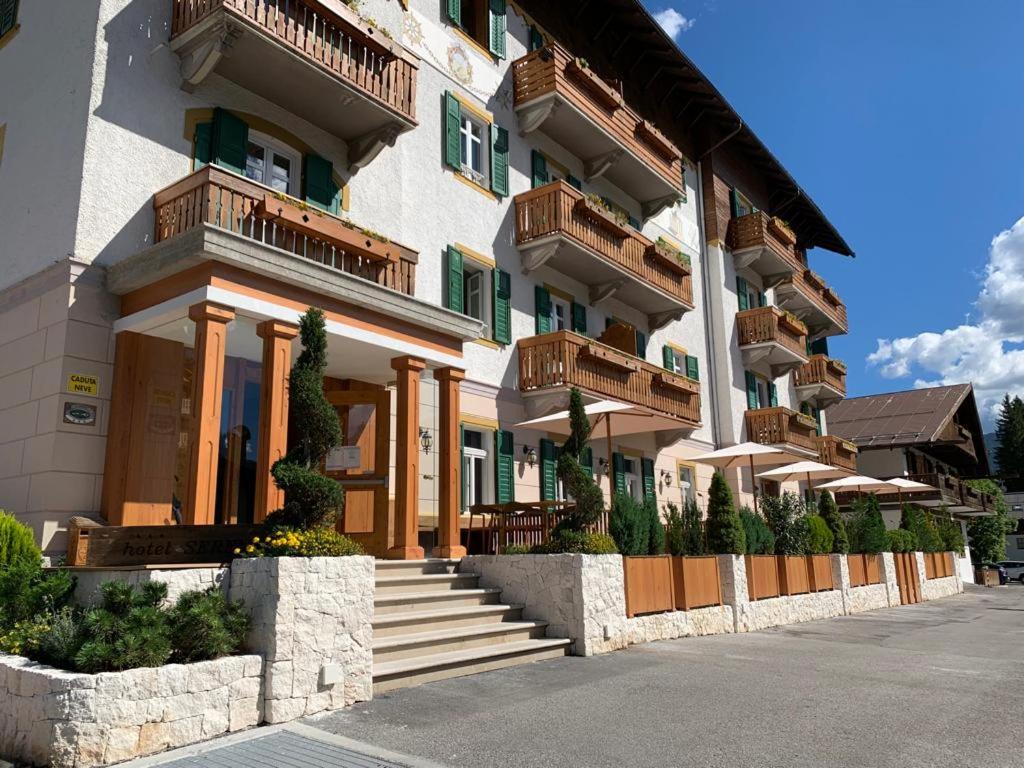 a building with balconies on the side of it at Hotel Serena Cortina in Cortina dʼAmpezzo