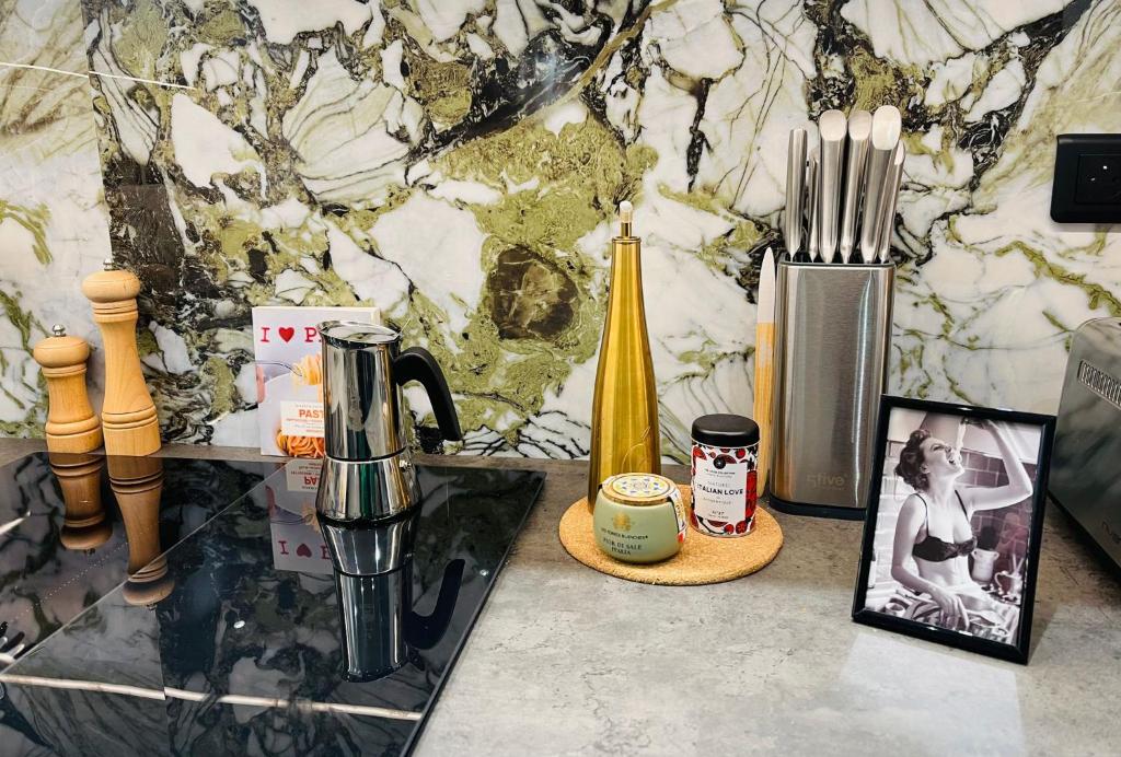 a counter top with a bottle of champagne and other items at Toscana - Luxury Duplex Rouen in Rouen