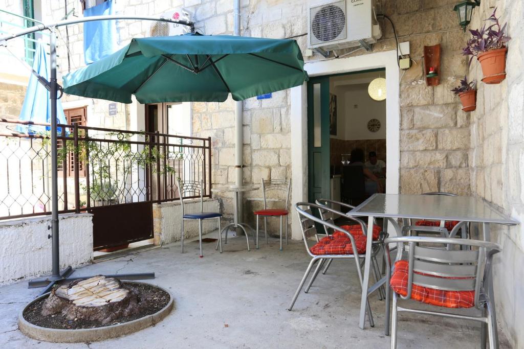 a table and chairs and an umbrella on a patio at Apartments with WiFi Split - 10243 in Split