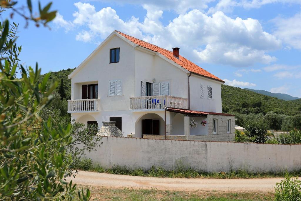 a white house with an orange roof at Apartments by the sea Drace, Peljesac - 10126 in Drače