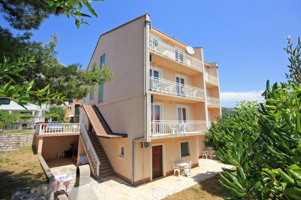 an external view of a building with a balcony at Apartments and rooms with parking space Orebic, Peljesac - 10192 in Orebić