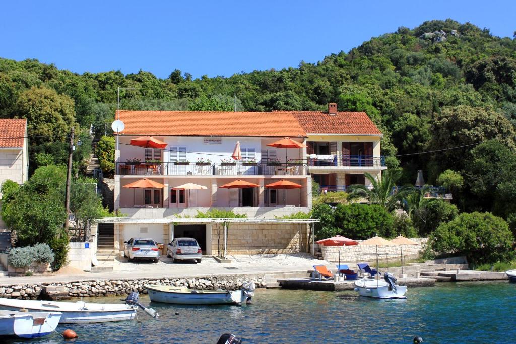 dom na wodzie z łodziami przed nim w obiekcie Apartments by the sea Zrnovska Banja, Korcula - 10050 w Korčuli