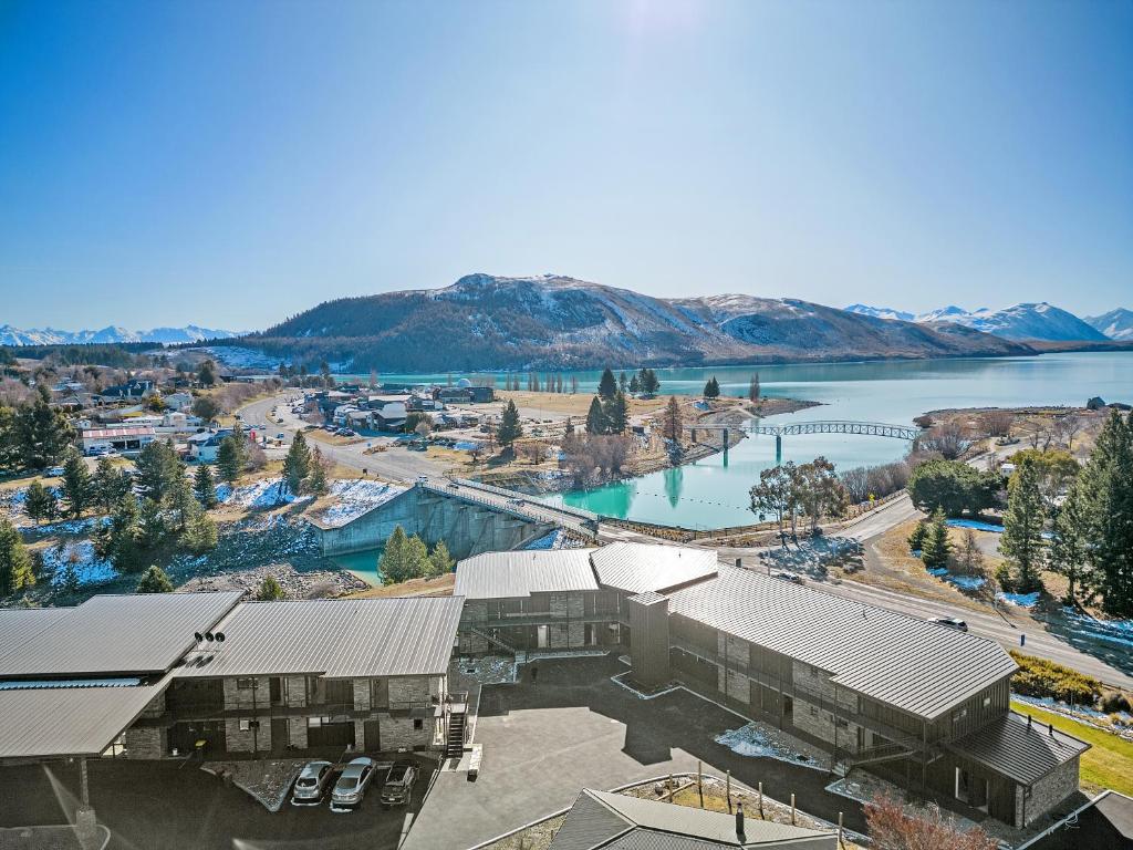 an aerial view of a building next to a body of water at Grand Suites Lake Tekapo in Lake Tekapo